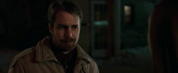 Movie still from “Snow Angels” (2007), directed by David Gordon Green – A person wearing a jacket and a tie; Close Up shot, Over the shoulder angle