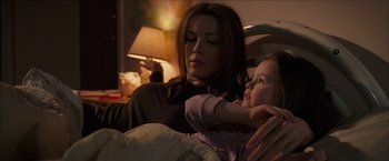 Movie still from “Snow Angels” (2007), directed by David Gordon Green – A woman sitting next to a little girl in a bed; Medium shot, Over the shoulder angle