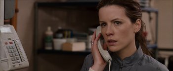 Movie still from “Snow Angels” (2007), directed by David Gordon Green – A woman holding a phone up to her ear; Close Up shot, High angle