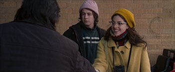 Movie still from “Snow Angels” (2007), directed by David Gordon Green – A man and a woman standing next to each other; Medium shot, Over the shoulder angle