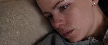Movie still from “Snow Angels” (2007), directed by David Gordon Green – A woman's face as she lies on a couch; Close Up shot, Overhead angle