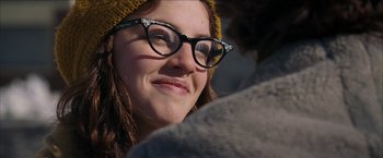 Movie still from “Snow Angels” (2007), directed by David Gordon Green – A person wearing glasses and a hat; Close Up shot, Over the shoulder angle