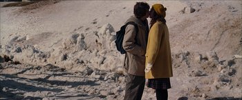 Movie still from “Snow Angels” (2007), directed by David Gordon Green – A man and a woman kissing in the snow; Medium shot, Low angle
