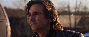 Movie still from “Snow Angels” (2007), directed by David Gordon Green – A person with long brown hair; Close Up shot, Low angle