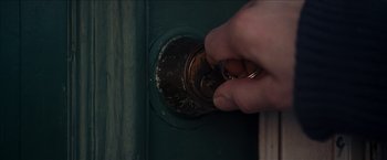 Movie still from “Snow Angels” (2007), directed by David Gordon Green – A hand is holding a key to a door knob; Extreme Close Up shot, High angle