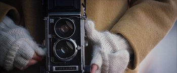 Movie still from “Snow Angels” (2007), directed by David Gordon Green – An old fashioned camera with a sweater on the side; Extreme Close Up shot, Overhead angle