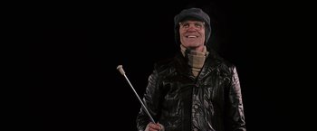 Movie still from “Snow Angels” (2007), directed by David Gordon Green – A man holding a stick while wearing a leather jacket; Close Up shot, Low angle