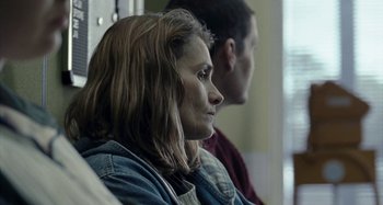 Movie still from “The Snowtown Murders” (2011), directed by Justin Kurzel – A woman sitting next to a man in a room; Close Up shot, Over the shoulder angle