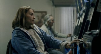 Movie still from “The Snowtown Murders” (2011), directed by Justin Kurzel – A woman sitting in front of a computer monitor; Medium shot, Over the shoulder angle