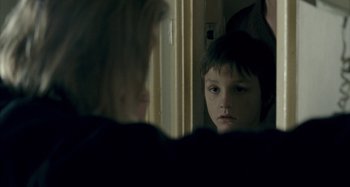 Movie still from “The Snowtown Murders” (2011), directed by Justin Kurzel – A young boy looking at his reflection in a mirror; Close Up shot, Over the shoulder angle