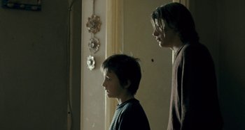 Movie still from “The Snowtown Murders” (2011), directed by Justin Kurzel – Two people standing next to each other in a room; Medium shot, Low angle