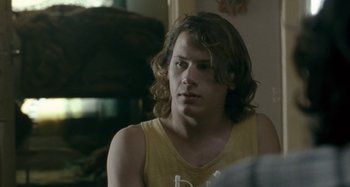 Movie still from “The Snowtown Murders” (2011), directed by Justin Kurzel – A man with long hair sitting in front of a mirror; Close Up shot, Over the shoulder angle