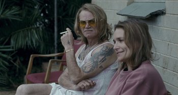 Movie still from “The Snowtown Murders” (2011), directed by Justin Kurzel – A man and a woman sitting next to each other; Medium shot, Over the shoulder angle