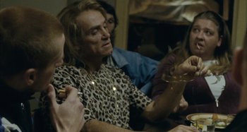 Movie still from “The Snowtown Murders” (2011), directed by Justin Kurzel – A group of people sitting around a table; Medium shot, Over the shoulder angle