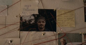 Movie still from “The Snowtown Murders” (2011), directed by Justin Kurzel – A bunch of papers stuck to a wall with a picture of a man; Extreme Close Up shot, Overhead angle