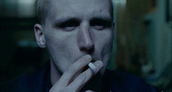 Movie still from “The Snowtown Murders” (2011), directed by Justin Kurzel – A person smoking a cigarette; Close Up shot, Over the shoulder angle