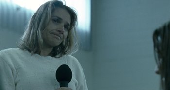 Movie still from “The Snowtown Murders” (2011), directed by Justin Kurzel – A person holding a microphone in their hand; Close Up shot, Over the shoulder angle