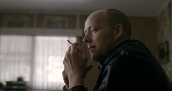 Movie still from “The Snowtown Murders” (2011), directed by Justin Kurzel – A man holding a cigarette in his hand; Close Up shot, Low angle
