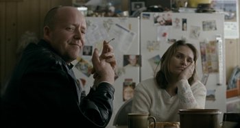 Movie still from “The Snowtown Murders” (2011), directed by Justin Kurzel – A man and a woman sitting at a table; Medium shot, Over the shoulder angle