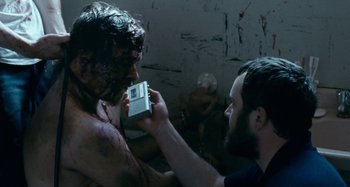 Movie still from “The Snowtown Murders” (2011), directed by Justin Kurzel – A man holding a video game controller in his hands; Close Up shot, Over the shoulder angle