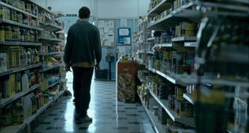 Movie still from “The Snowtown Murders” (2011), directed by Justin Kurzel – A man walking down the aisle of a grocery store; Wide shot, Low angle