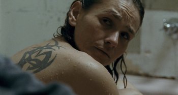 Movie still from “The Snowtown Murders” (2011), directed by Justin Kurzel – A person with a tattoo on their shoulder; Close Up shot, High angle