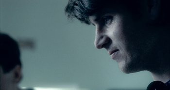 Movie still from “The Snowtown Murders” (2011), directed by Justin Kurzel – A man's face in a dark room; Extreme Close Up shot, Over the shoulder angle
