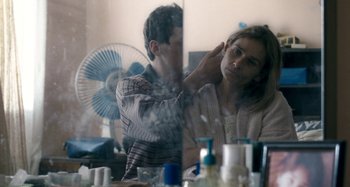 Movie still from “The Snowtown Murders” (2011), directed by Justin Kurzel – A man and a woman in front of a mirror; Close Up shot, Over the shoulder angle
