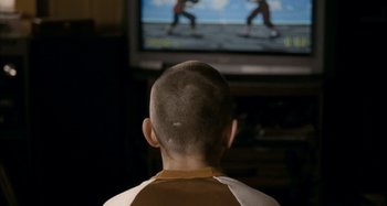Movie still from “The Snowtown Murders” (2011), directed by Justin Kurzel – A young boy is watching a video on the television; Close Up shot, Over the shoulder angle