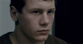 Movie still from “The Snowtown Murders” (2011), directed by Justin Kurzel – A young man's face; Close Up shot, Over the shoulder angle