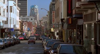Movie still from “So I Married an Axe Murderer” (1993), directed by Thomas Schlamme – A city street filled with lots of traffic and buildings; Extreme Wide shot, High angle