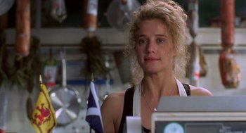 Movie still from “So I Married an Axe Murderer” (1993), directed by Thomas Schlamme – A woman with curly blonde hair standing in a kitchen; Close Up shot, Low angle