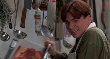 Movie still from “So I Married an Axe Murderer” (1993), directed by Thomas Schlamme – A man in a kitchen holding a spatula; Close Up shot, Over the shoulder angle