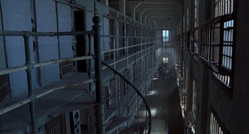 Movie still from “So I Married an Axe Murderer” (1993), directed by Thomas Schlamme – A long hallway in an old prison building; Extreme Wide shot, High angle