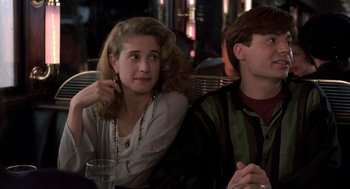 Movie still from “So I Married an Axe Murderer” (1993), directed by Thomas Schlamme – A woman sitting next to a man at a table; Close Up shot, Over the shoulder angle