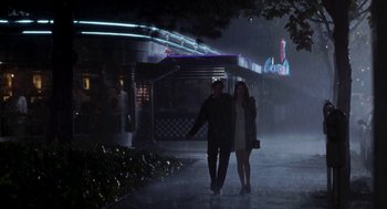 Movie still from “So I Married an Axe Murderer” (1993), directed by Thomas Schlamme – A man and a woman are walking in the rain; Wide shot, Low angle