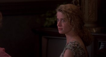 Movie still from “So I Married an Axe Murderer” (1993), directed by Thomas Schlamme – A beautiful young woman with curly red hair wearing a floral dress; Close Up shot, Over the shoulder angle