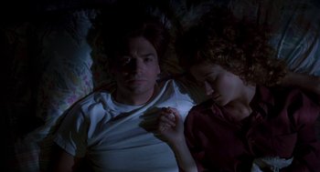 Movie still from “So I Married an Axe Murderer” (1993), directed by Thomas Schlamme – A man and a woman laying in a bed together; Medium shot, Overhead angle