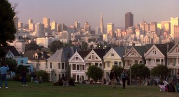 Movie still from “So I Married an Axe Murderer” (1993), directed by Thomas Schlamme – A group of people standing on top of a grass covered field; Extreme Wide shot, High angle