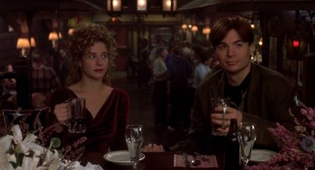 Movie still from “So I Married an Axe Murderer” (1993), directed by Thomas Schlamme – A man and a woman sitting at a table with drinks; Medium shot, Over the shoulder angle