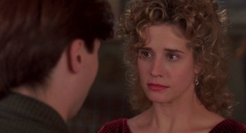 Movie still from “So I Married an Axe Murderer” (1993), directed by Thomas Schlamme – A young woman with curly hair is looking at a young man; Close Up shot, Over the shoulder angle