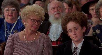 Movie still from “So I Married an Axe Murderer” (1993), directed by Thomas Schlamme – A woman and a man sitting next to each other in front of an audience; Close Up shot, Over the shoulder angle