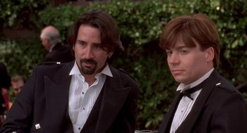 Movie still from “So I Married an Axe Murderer” (1993), directed by Thomas Schlamme – A man and a boy in tuxedos standing next to each other; Close Up shot, Low angle