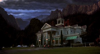Movie still from “So I Married an Axe Murderer” (1993), directed by Thomas Schlamme – A large white house with a car parked in front of it at night; Extreme Wide shot, Low angle
