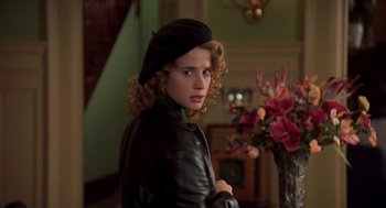 Movie still from “So I Married an Axe Murderer” (1993), directed by Thomas Schlamme – A young woman wearing a black leather jacket and a black hat; Close Up shot, Over the shoulder angle