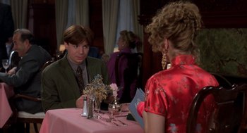 Movie still from “So I Married an Axe Murderer” (1993), directed by Thomas Schlamme – A man and a woman are sitting at a table; Medium shot, Over the shoulder angle