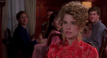 Movie still from “So I Married an Axe Murderer” (1993), directed by Thomas Schlamme – A woman in a red dress and some other people in the background; Close Up shot, Over the shoulder angle