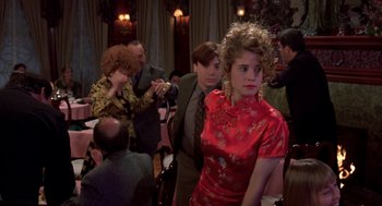 Movie still from “So I Married an Axe Murderer” (1993), directed by Thomas Schlamme – A group of people sitting at tables in a room; Medium shot, Over the shoulder angle