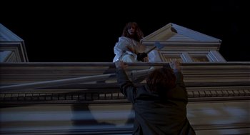 Movie still from “So I Married an Axe Murderer” (1993), directed by Thomas Schlamme – A woman standing on top of a building next to a man; Wide shot, Low angle