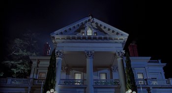 Movie still from “So I Married an Axe Murderer” (1993), directed by Thomas Schlamme – A large building with columns at night time; Extreme Wide shot, Low angle